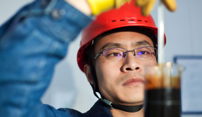 man testing oil in laboratory